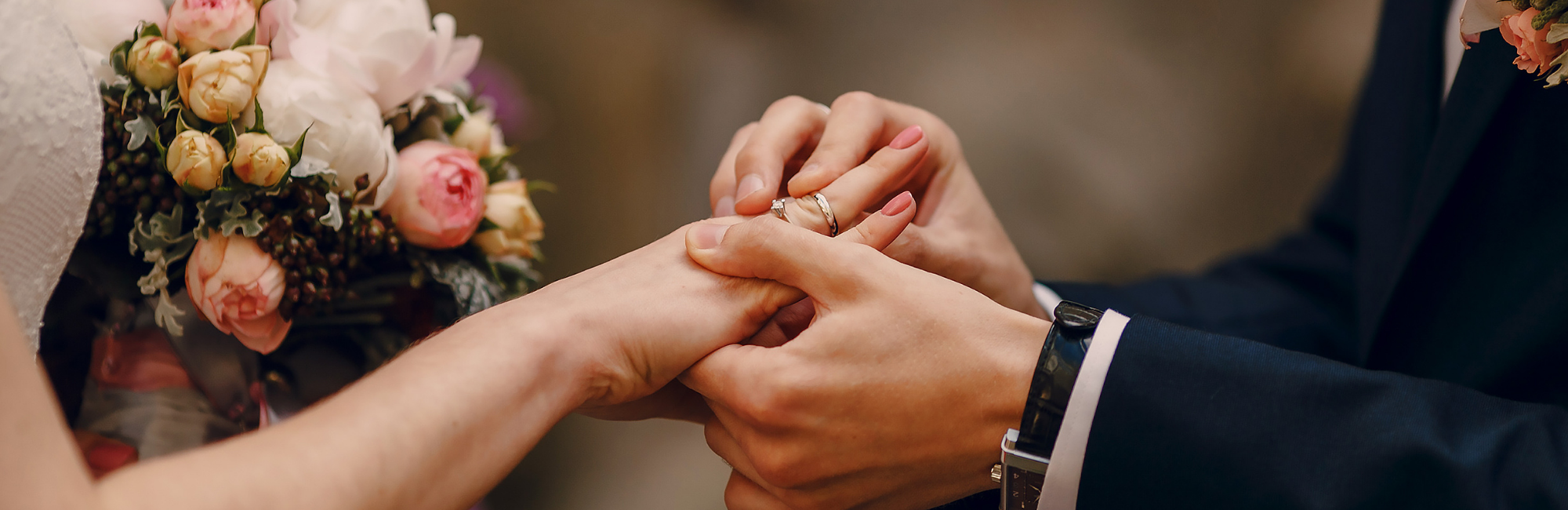 groom placing ring on bride's finger